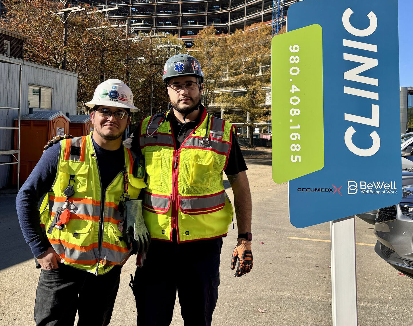 Two OccuMedX medics posing with an onsite clinic sign.